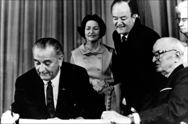 President Lyndon Johnson signs Medicare into law 